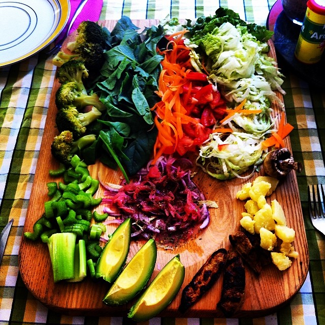 Cutting board full of fruits and vegetables