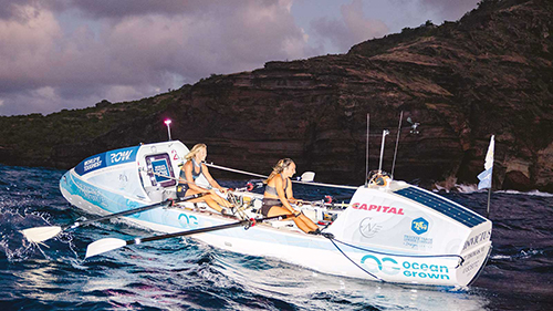 UMD Alum in a rowboat with teammate