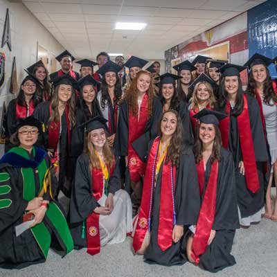 Graduates smiling before the ceremony