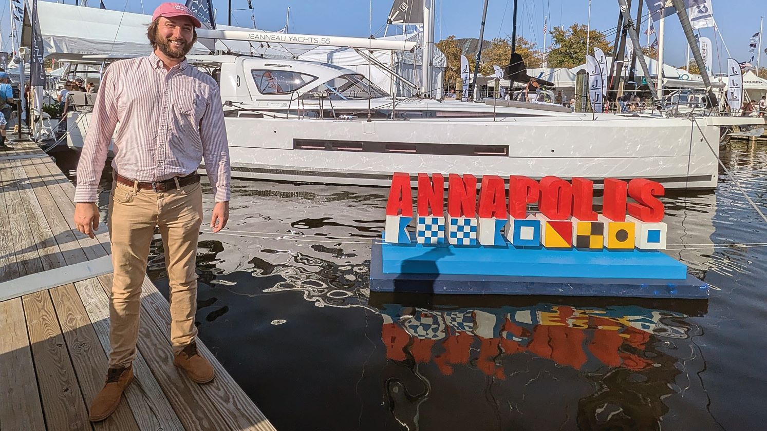 Harry Huntley in front of a boat the Annapolis city dock