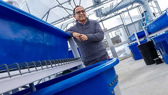 Izursa poses at the new aquaponics lab, scheduled to open this month.
