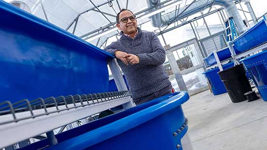 Izursa poses at the new aquaponics lab, scheduled to open this month.