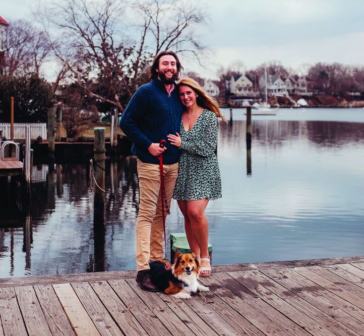 Huntley and his wife, Sara Ramotnik (also an UMD 2020 graduate) and pup Hobie on the waterfront of their home town, Annapolis.