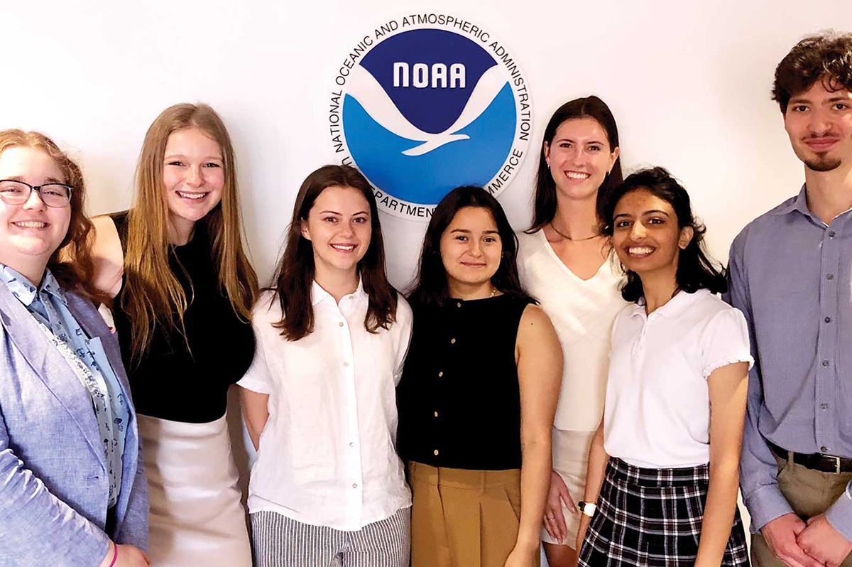 ENSP students standing in front of a NOAA sign smiling 