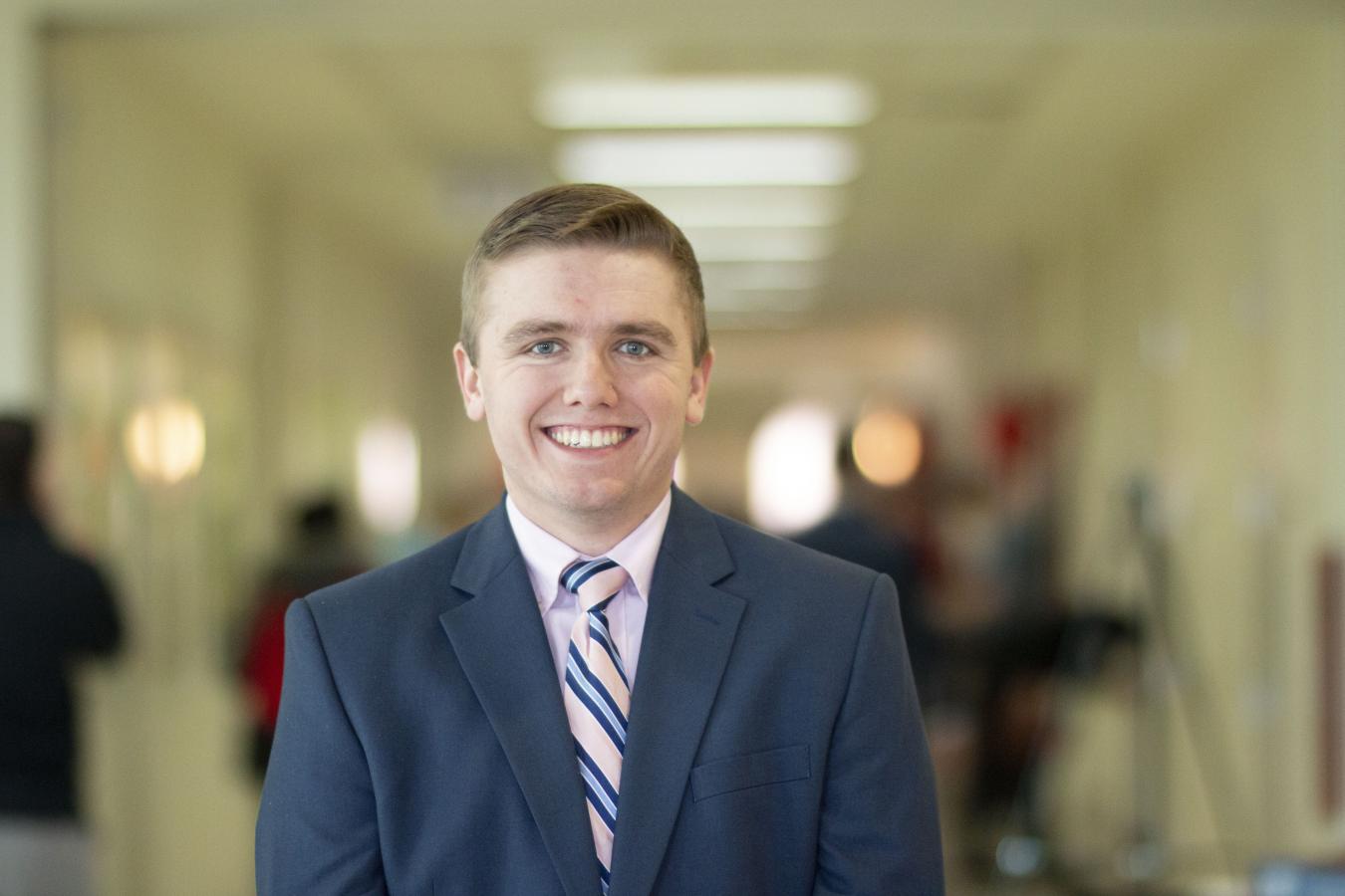 Photo of AGNR Featured Alum Zach Jones standing in a busy hallway