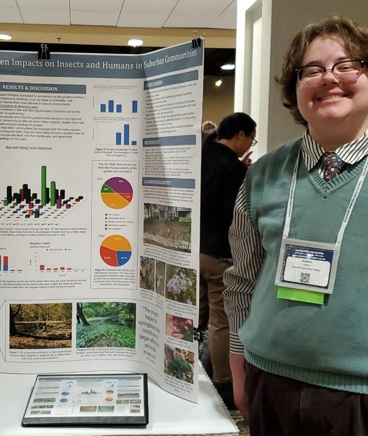 Joyful UMD student posing with his scientific poster, "First Year Native Garden Impacts on Insects and Humans in Suburban Communities."
