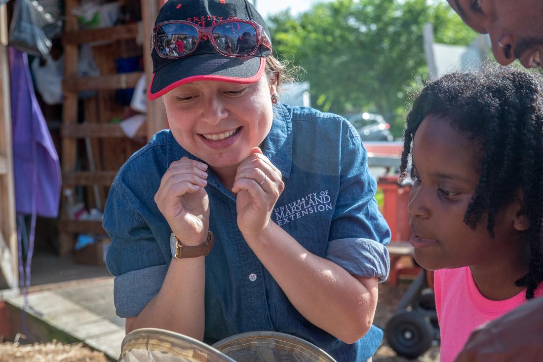 Extension employee helping a person out at an event