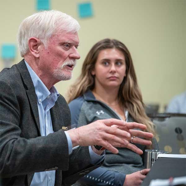 Faculty and student at an event