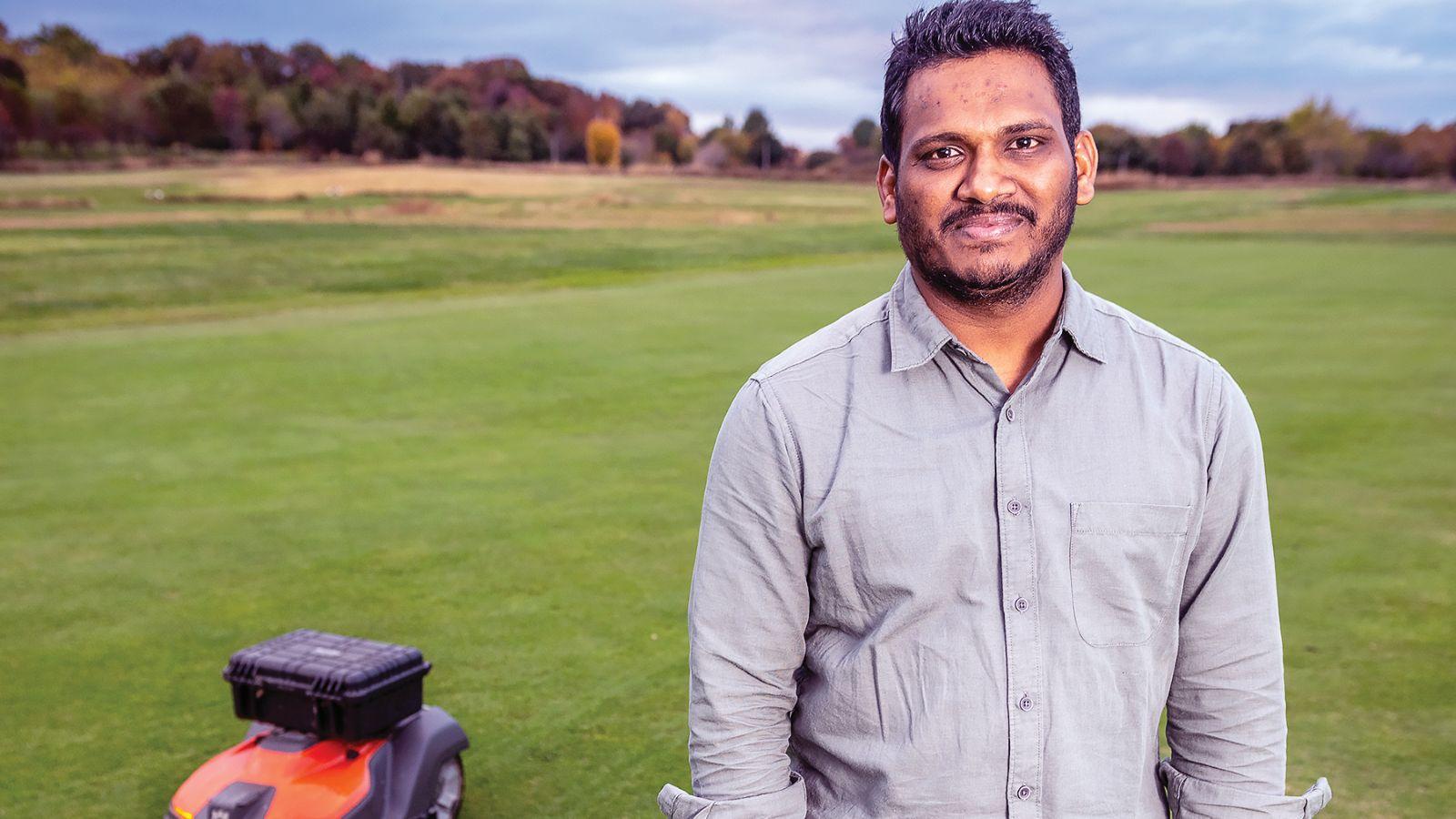 UDAY KUMAR THERA standing in a field with a robotic fungus zapper