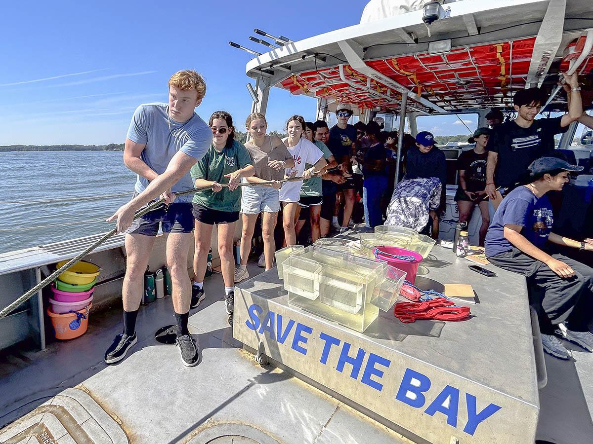 AGNR students on a boat pulling a rope